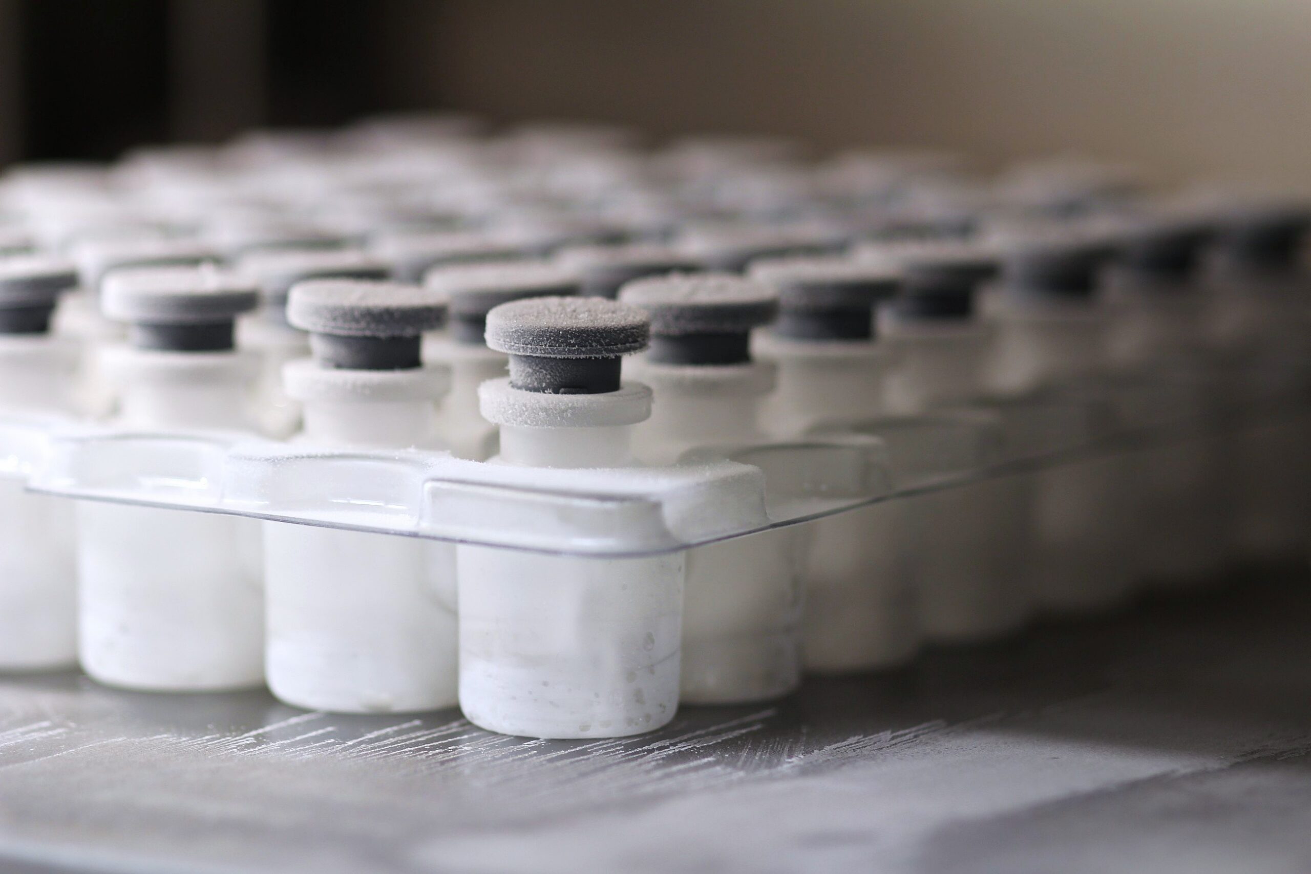 Glass vials frozen and frosted in a nested tray after freezing